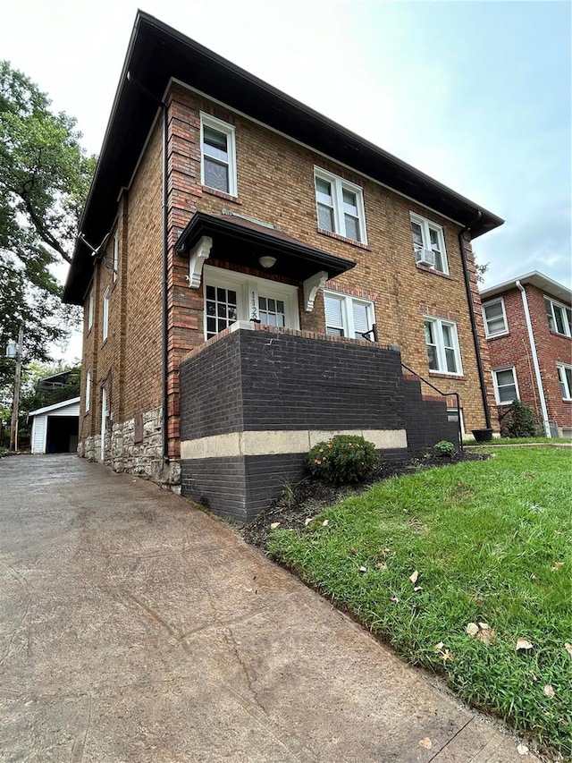 view of front facade featuring an outbuilding and brick siding