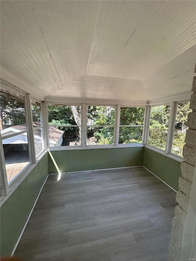 unfurnished sunroom with lofted ceiling and wooden ceiling