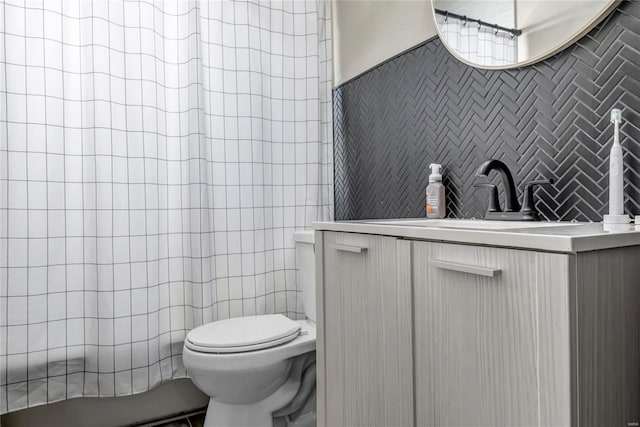 full bathroom with toilet, curtained shower, vanity, and tile walls