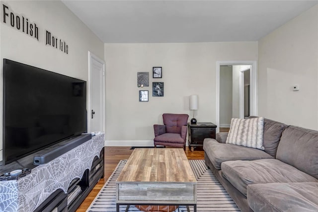 living room with baseboards and wood finished floors