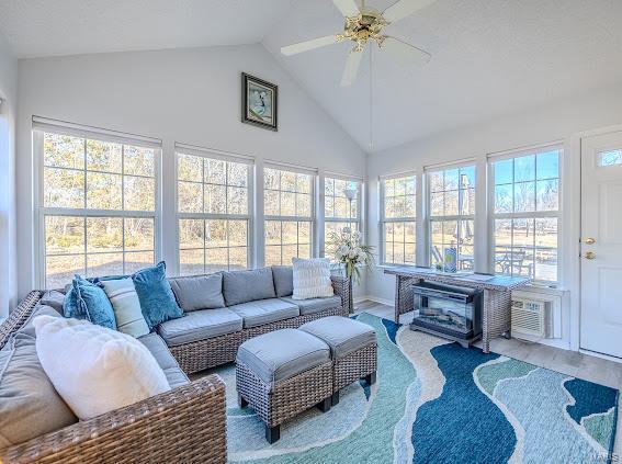 sunroom / solarium featuring lofted ceiling and ceiling fan