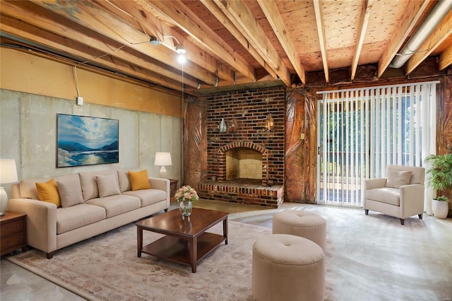 living area featuring a brick fireplace and concrete floors