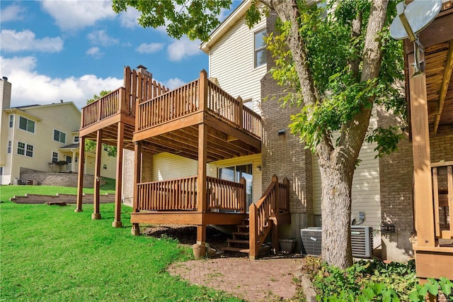 rear view of property with a yard, central AC, a patio, and a wooden deck