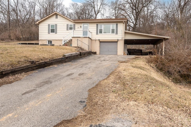 ranch-style house with a carport, driveway, and a garage