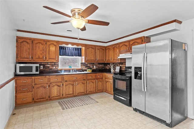 kitchen featuring under cabinet range hood, appliances with stainless steel finishes, and brown cabinetry