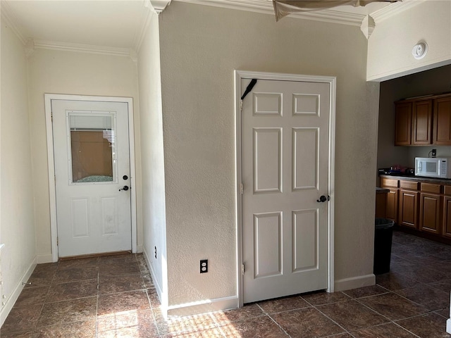 corridor featuring a textured wall, ornamental molding, and baseboards