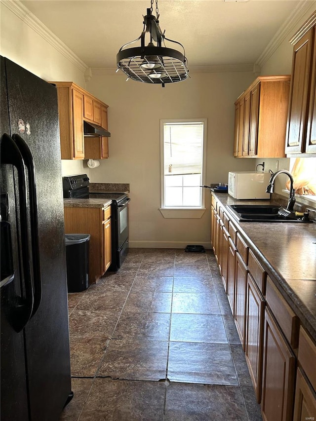 kitchen with dark countertops, under cabinet range hood, crown molding, black appliances, and a sink