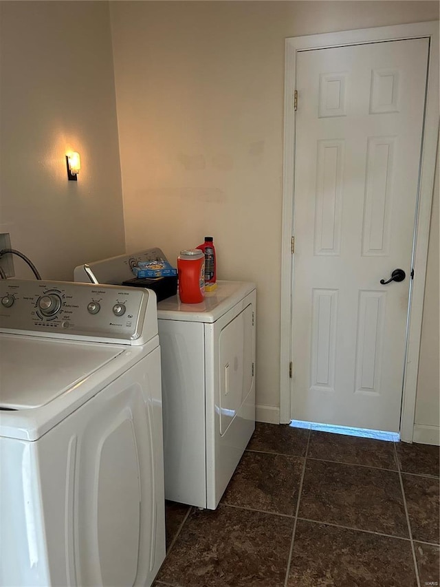 laundry area with laundry area, dark tile patterned floors, and washer and dryer