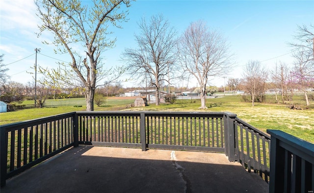 deck featuring a lawn, an outdoor structure, and a storage shed