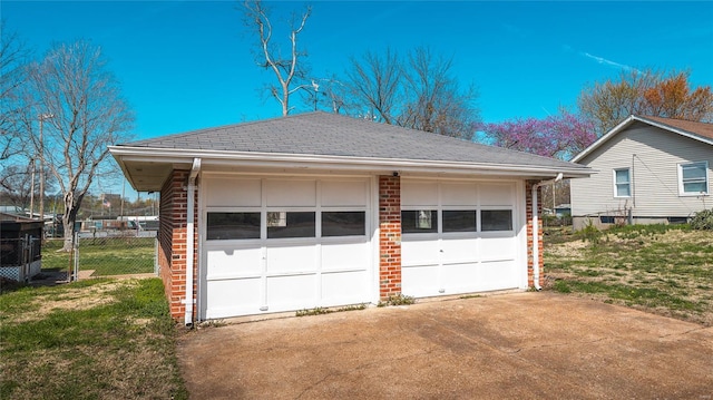 detached garage featuring fence