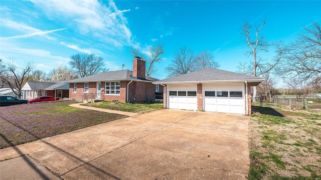 view of front facade featuring a chimney, fence, a front lawn, an outbuilding, and brick siding