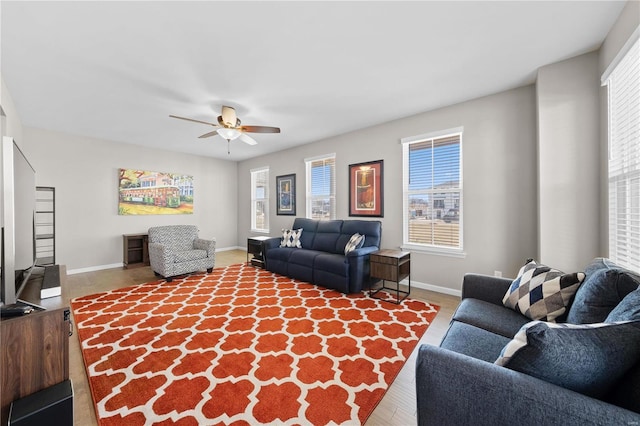 living room with ceiling fan, wood finished floors, and baseboards