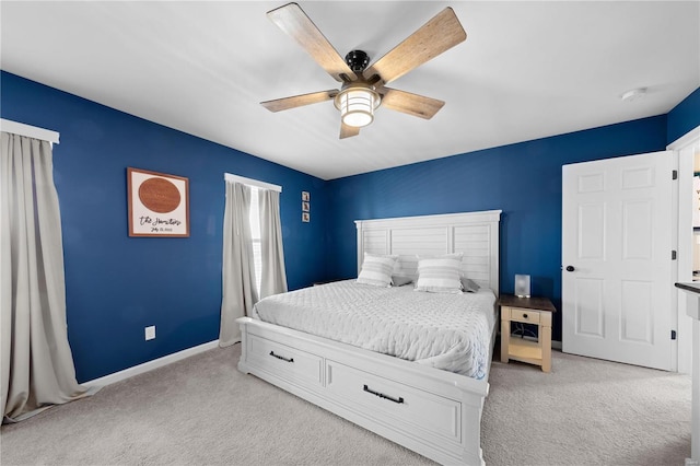 bedroom with a ceiling fan, light colored carpet, and baseboards