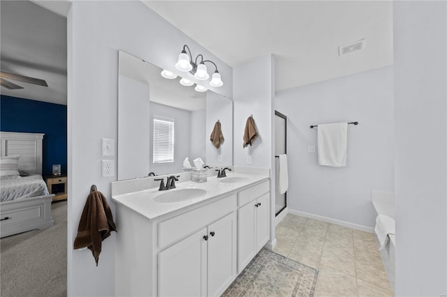 bathroom with double vanity, a sink, a ceiling fan, and baseboards