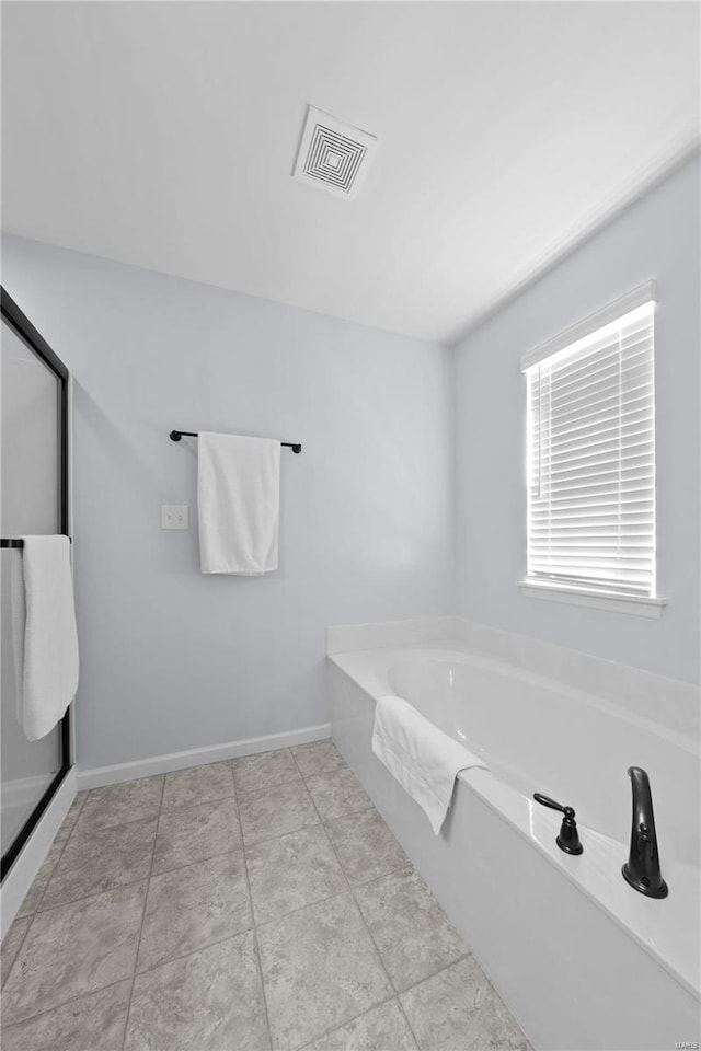 full bathroom featuring visible vents, baseboards, and a bath