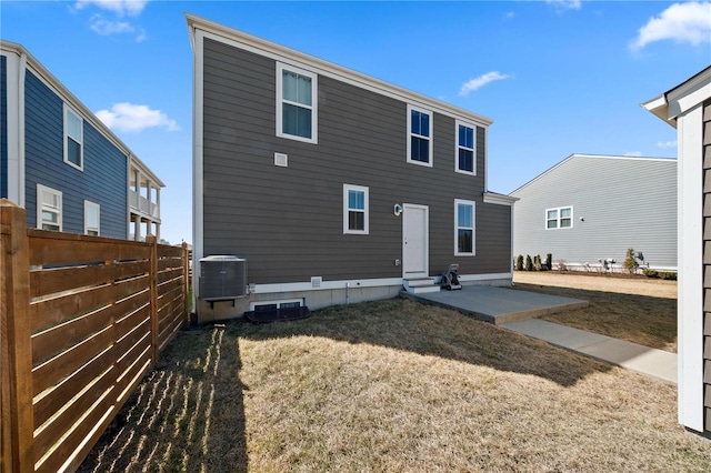 rear view of house with central air condition unit, a patio area, fence, and entry steps