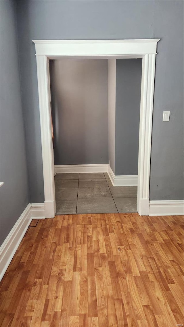 interior details with baseboards and wood finished floors