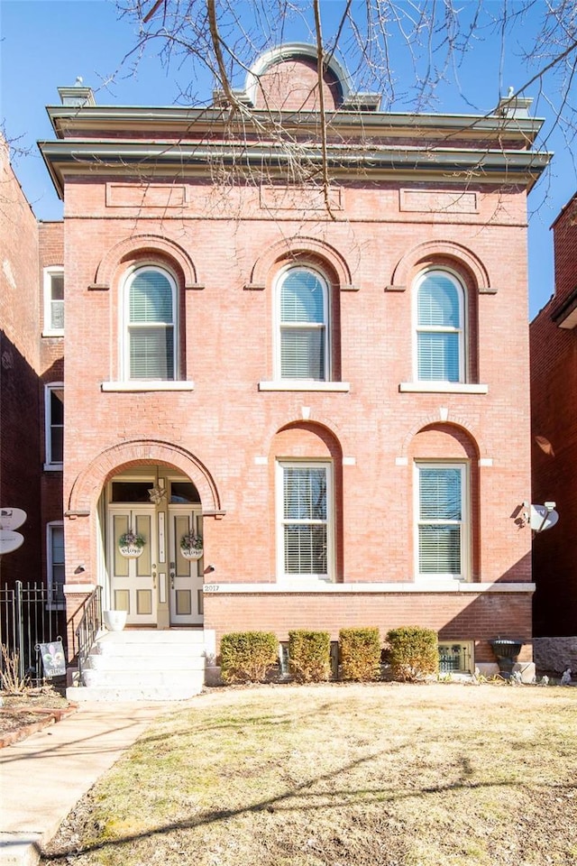 view of front of home featuring brick siding