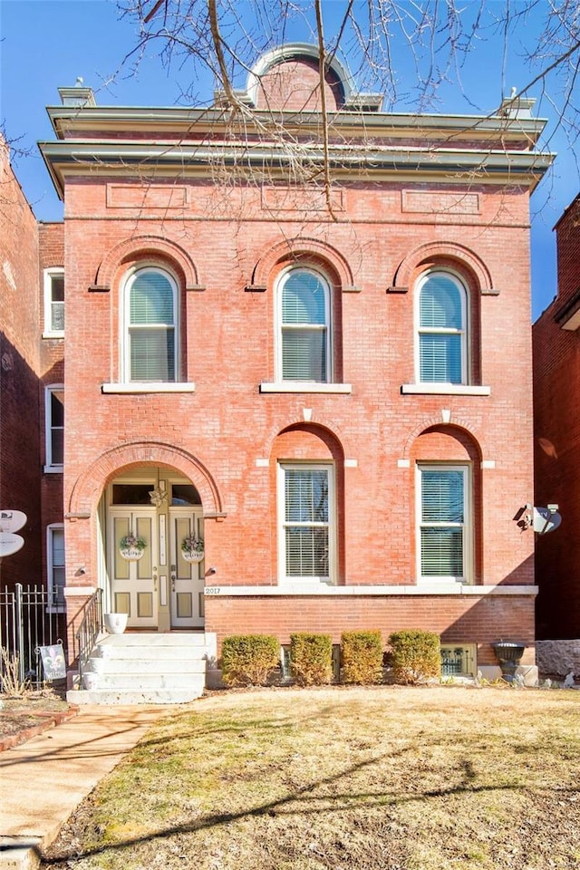 view of front of property featuring brick siding