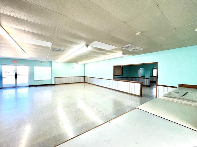 interior space with visible vents and a drop ceiling