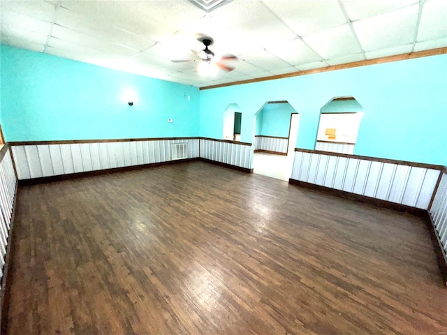 unfurnished room featuring a ceiling fan, visible vents, a drop ceiling, and wood finished floors