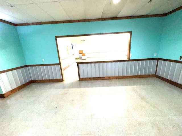 unfurnished room featuring a paneled ceiling