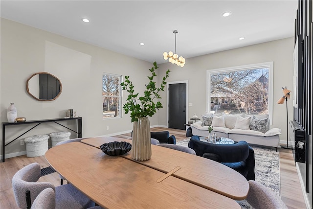 dining room featuring light wood-type flooring, baseboards, a wealth of natural light, and recessed lighting