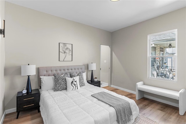 bedroom featuring baseboards and wood finished floors