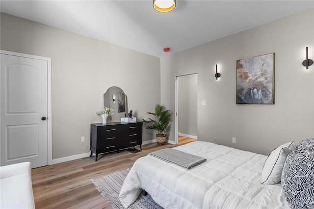 bedroom featuring light wood-type flooring and baseboards