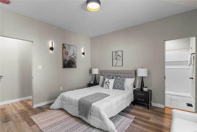 bedroom featuring baseboards and wood finished floors