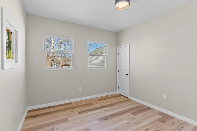 empty room with light wood-type flooring and baseboards