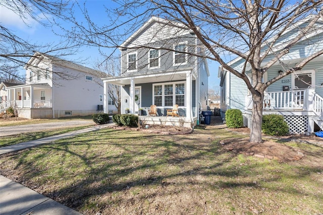 view of front facade with a porch and a front lawn