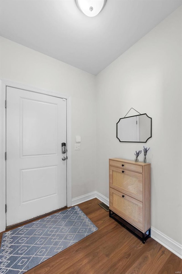 entryway with visible vents, baseboards, and wood finished floors