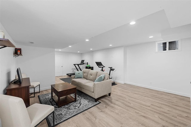 living area with light wood-style flooring, visible vents, baseboards, and recessed lighting