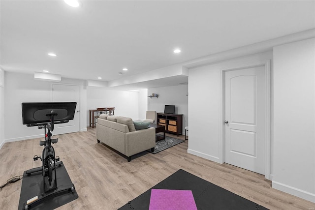 workout room with light wood finished floors, baseboards, and recessed lighting