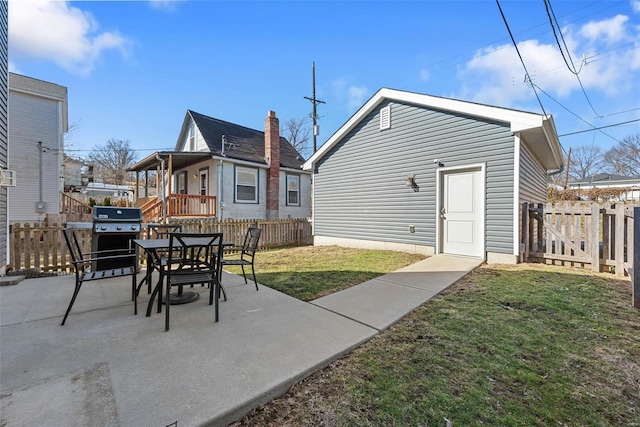 exterior space featuring a patio, a lawn, and a fenced backyard