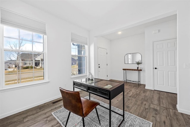 office space featuring visible vents, baseboards, and wood finished floors