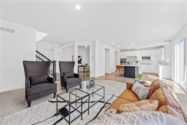 living room with stairs, baseboards, visible vents, and recessed lighting