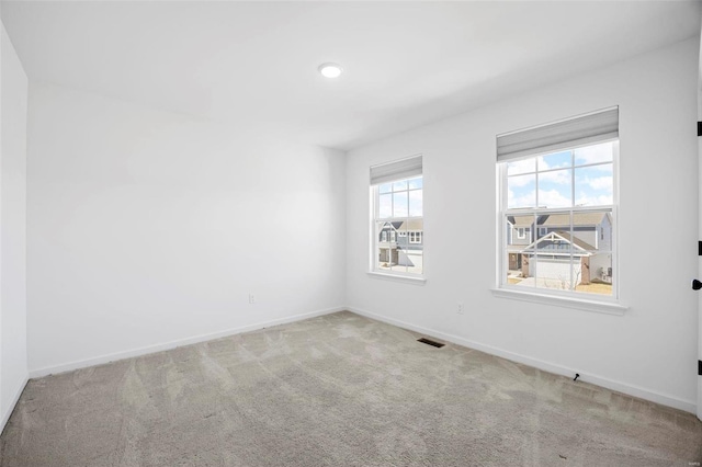 empty room with recessed lighting, carpet flooring, visible vents, and baseboards