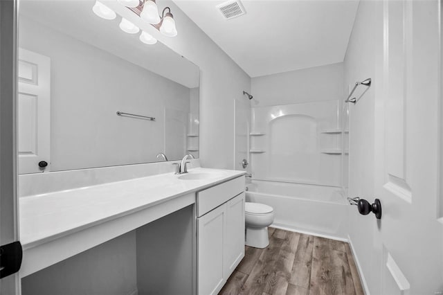 full bathroom featuring toilet, wood finished floors, vanity, visible vents, and shower / bathing tub combination