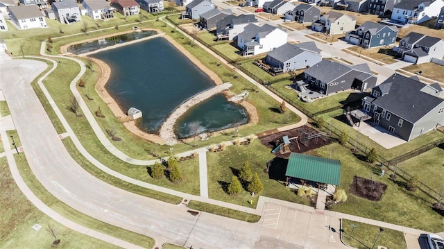 birds eye view of property with a water view and a residential view