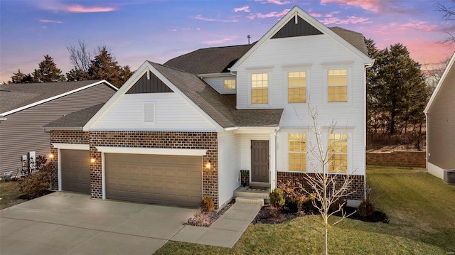 traditional-style home featuring brick siding, a yard, concrete driveway, an attached garage, and board and batten siding