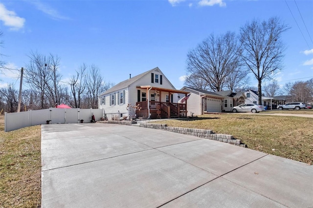 view of front of house featuring a porch, an attached garage, fence, driveway, and a front lawn