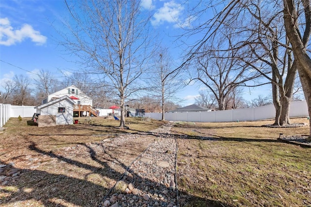 view of yard with a fenced backyard and an outbuilding