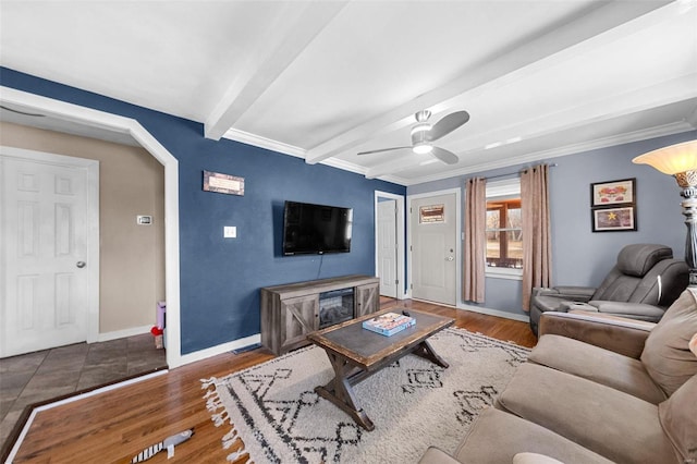 living room with arched walkways, dark wood finished floors, ceiling fan, beamed ceiling, and baseboards