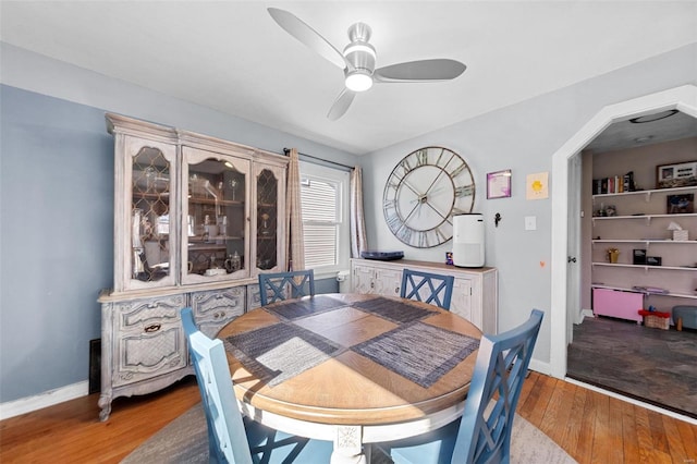 dining space with hardwood / wood-style flooring, ceiling fan, and baseboards