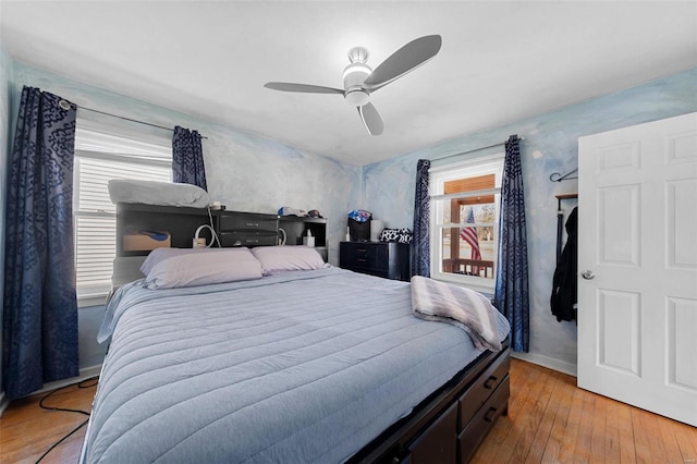 bedroom featuring baseboards, a ceiling fan, and light wood-style floors