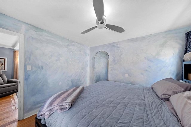 bedroom with ceiling fan and wood finished floors