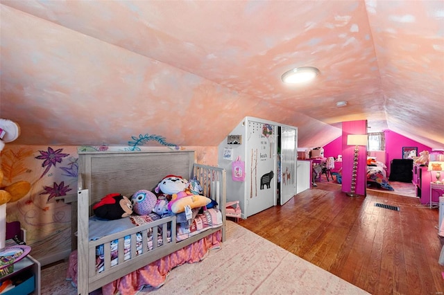 game room featuring vaulted ceiling and hardwood / wood-style floors