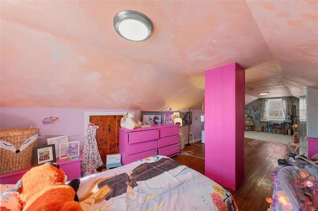 bedroom with lofted ceiling and dark wood-style floors